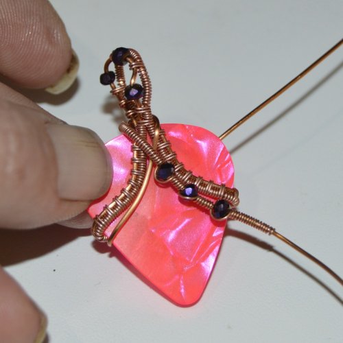 Deborah Kelly's Guitar Pick Pendant - , Wire Weaving, Weaving, Wire Weaving, Weaving Wire, Slip another bead on the wire being wrapped.