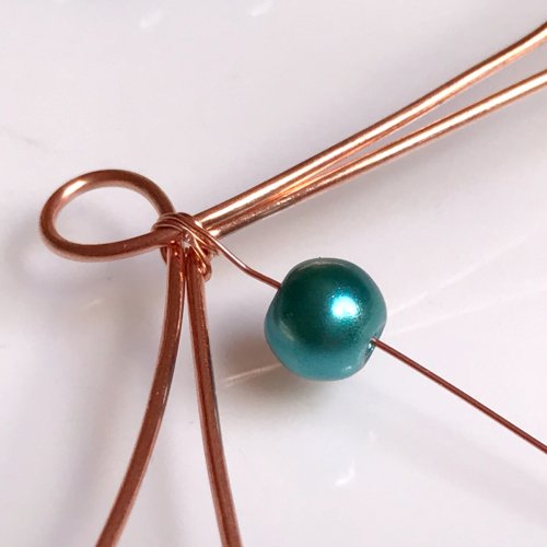 Erika Pal's Xs and Os Beaded Wire Bracelet - , Contemporary Wire Jewelry, Lashing, Wire Lashing, Loops, Wire Loop, Wrapped Wire Loop, Weaving, Wire Weaving, Weaving Wire, Beads, , Add a bead to the weaving wire.