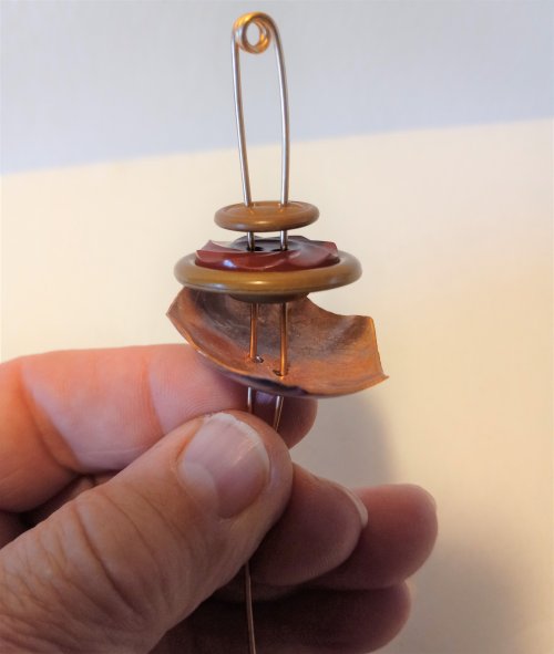 Judy Freyer Thompson's Stacked Button Charms - , Contemporary Wire Jewelry, Cutting, Cutting Tool, Cutters, Dapping, Dapping Jewelry, How To Punch Holes, Hole Punching, Punch A Hole, Loops, Wire Loop, Wrapped Wire Loop, Sawing, Saw, Wire Saw, Butane Torch, Soldering, Solder, Thread the tails from front to back going through 