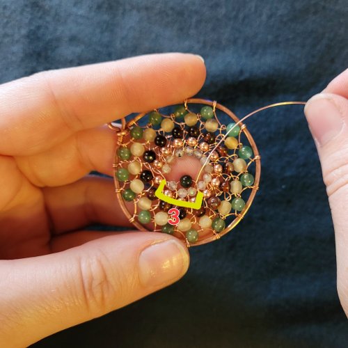 Jennifer Brooks's Dyer's Mushroom Netted Hoop Pendant - , Contemporary Wire Jewelry, Lashing, Wire Lashing, Wire Wrapping, Wrapping, Wire Wrapping Jewelry, , Thread the weaving wire from front to back.