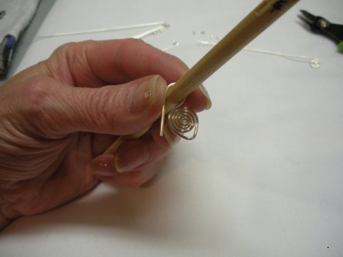 Judy Larson's Coiled Bead and Twisted Wire Bracelet - , Contemporary Wire Jewelry, Coiling, Coiling Wire, Wire Coiling, Wire Wrapping, Wrapping, Wire Wrapping Jewelry, , Bend the wire tail around the  mandrel as shown.    