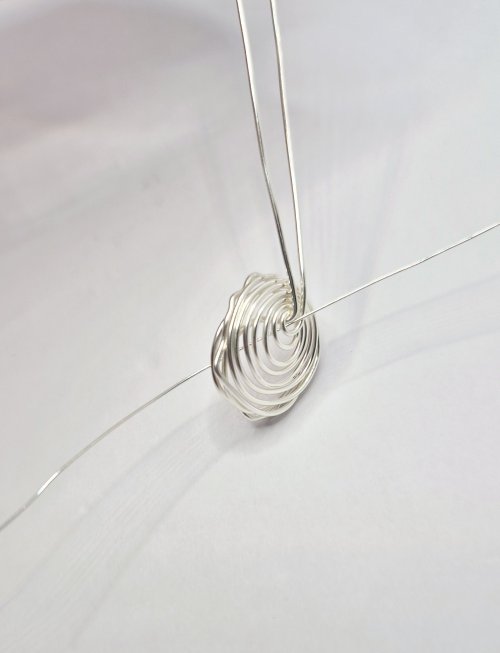 Natalie Patten's Birds Nest Pendant - , Contemporary Wire Jewelry, Wire Wrapping, Wrapping, Wire Wrapping Jewelry, Weaving, Wire Weaving, Weaving Wire, Bring wire through the center and out the front of the nest