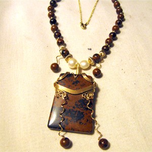 Joe Rushing's Obsidian Dangle Ladder Necklace, Classic Wire Jewelry. Wire Wrapping, Wrapping, Wire Wrapping Jewelry. Allow us to share our 2009 grand-prize winner, Joe Rushing, who won for his pendant entry!  Joe created a lovely piece, using gold-filled wire that was wrapped around a mahogany obsidian ladder pendant.